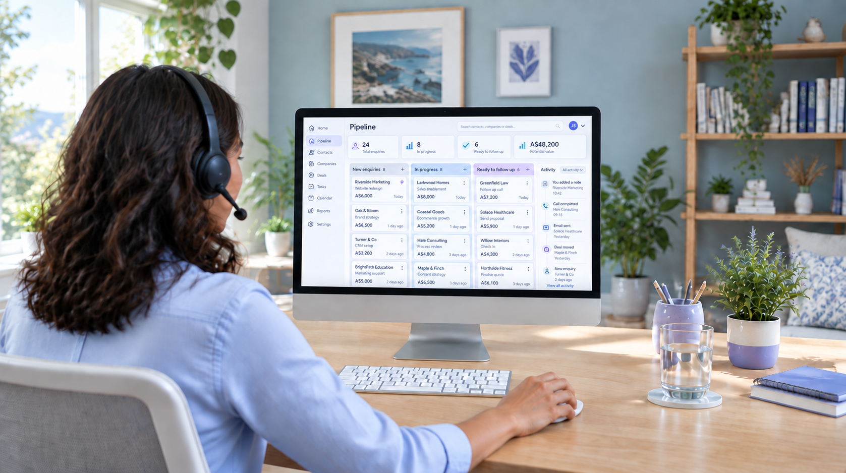 Illustrative team member updating a CRM at her home desk